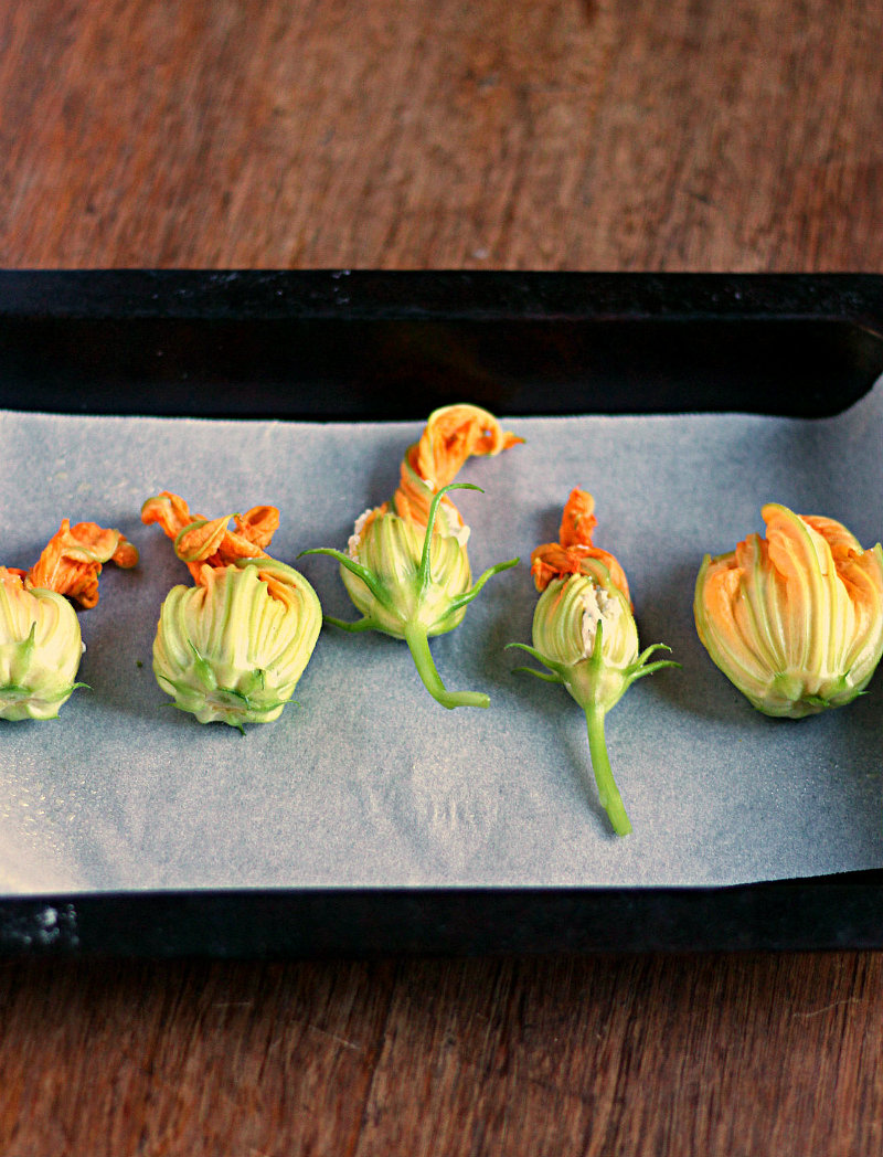 Stuffed and roasted zucchini flowers filled with a creamy vegan cashew cheese filling